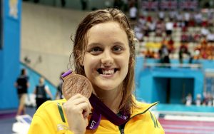 An image of Ellie Cole holding her bronze medal