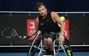 An image of Dylan Alcott in action during wheelchair tennis