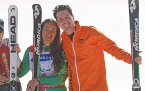 An image of Melissa Perrine and Christian Geiger smiling while holding ski equipment