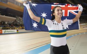 An image of para-cyclist Paige Greco smiling and holding the Australia flag