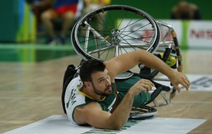 An image of Bill Latham in action during a wheelchair basketball game