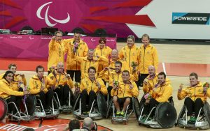 Australian wheelchair rugby team smiling with medal