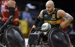 Image of male wheelchair rugby player Chris Bond with the ball