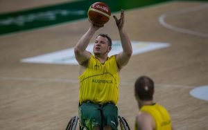 Australian male wheelchair basketball player taking a shot at goal