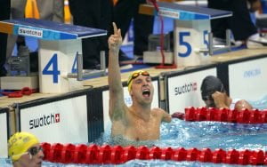 Male paralympic swimmer celebrates winning a race