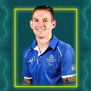 Image containing a dark green background with a yellow border. In the middle is a headshot of Australian para-athlete Rheed McCracken looking straight at the camera. He is wearing a blue t-shirt.