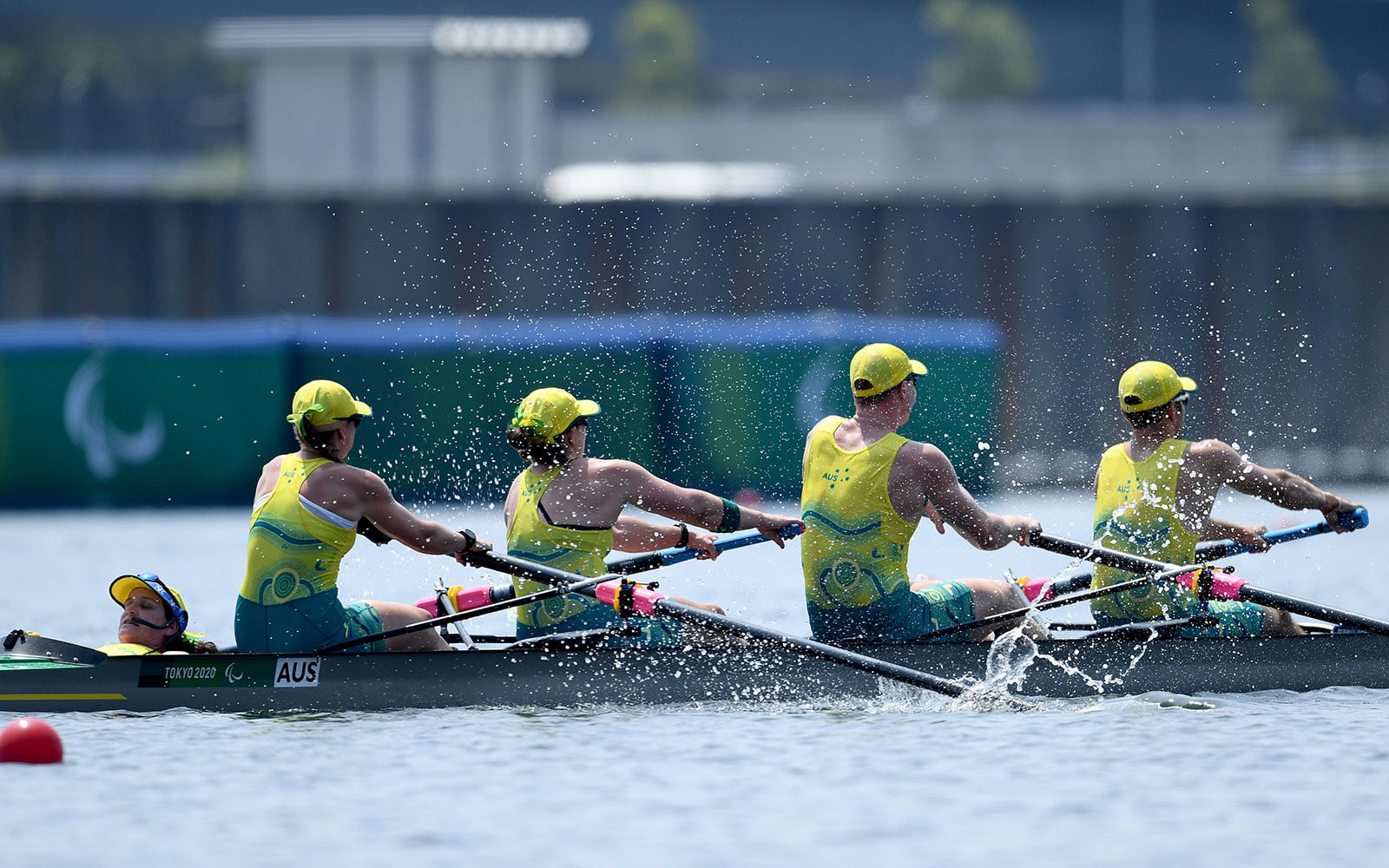 4 rowers in a boat competing on the water
