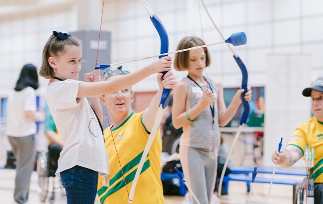 A young girl trying Para-archery at a Come & Try Day in Queensland