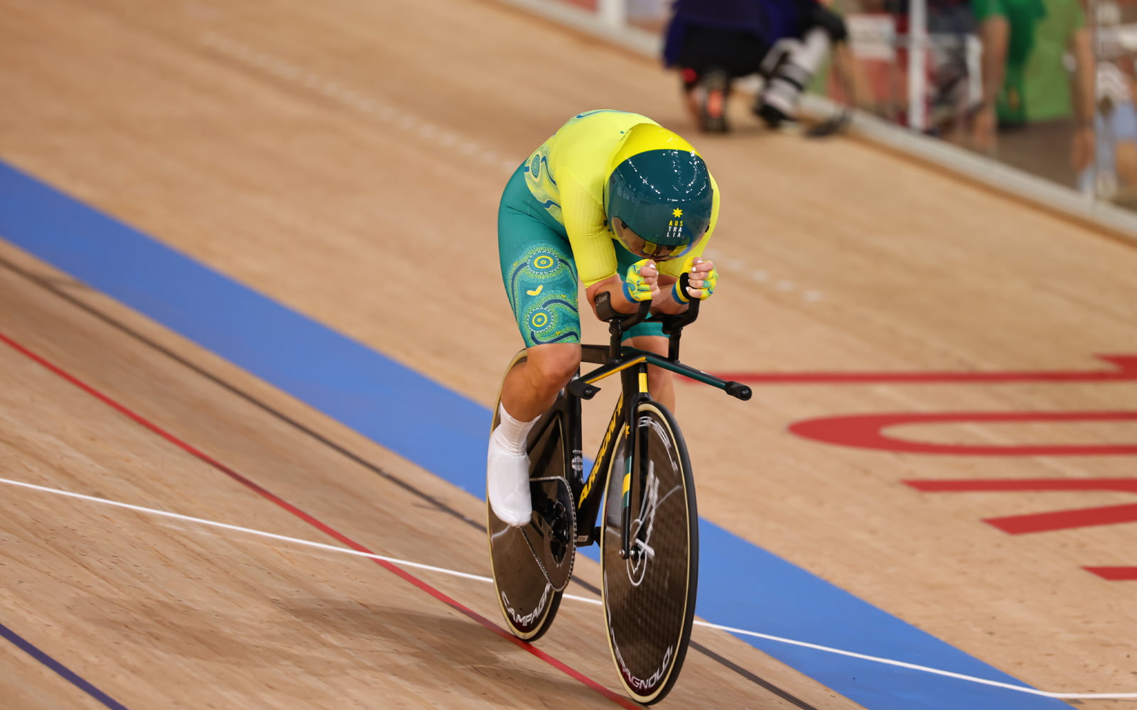 Australian Paralympian Emily Petricola cycling on a track.