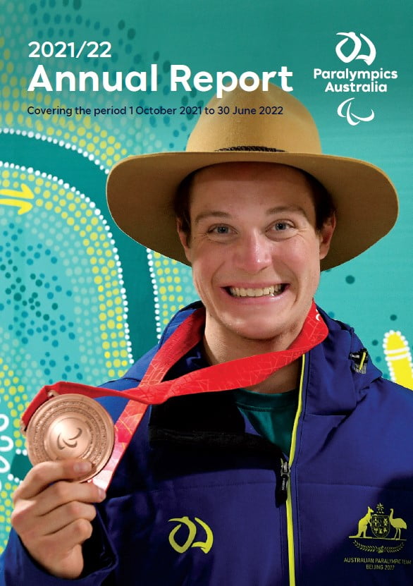 Australian Paralympian Ben Tudhope smiling and holding his bronze medal in his right hand. Text on image reads: 2021/22 Annual Report