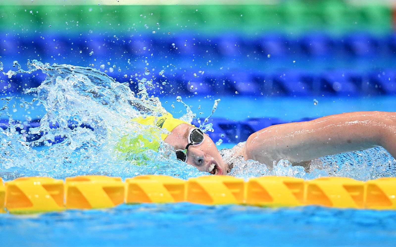 Australian Paralympian Lakeisha Patterson swimming. She is wearing goggles and a swimming cap.