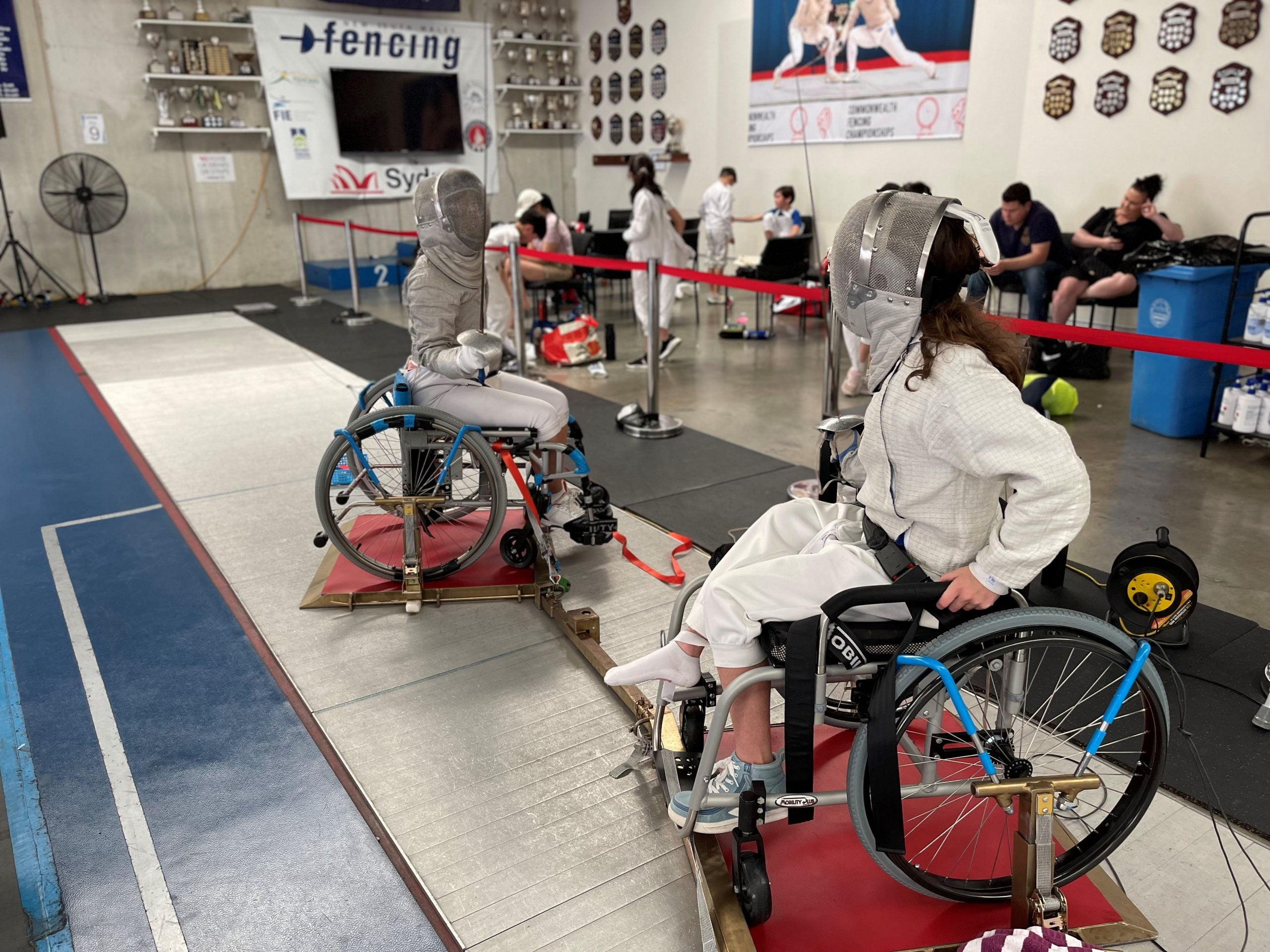 Children competing in wheelchair fencing.