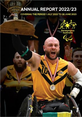 Australian wheelchair rugby captain Chris Bond holds a trophy above his head. Text reads: 2022/23 Annual Report