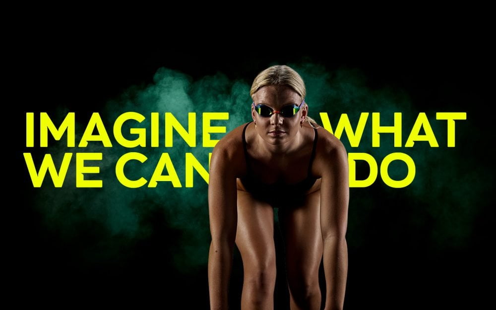 Australian Para-swimmer Ruby Storm in a black speedo swim suit with goggles getting ready to dive off the block. Text reads: Imagine What We Can Do