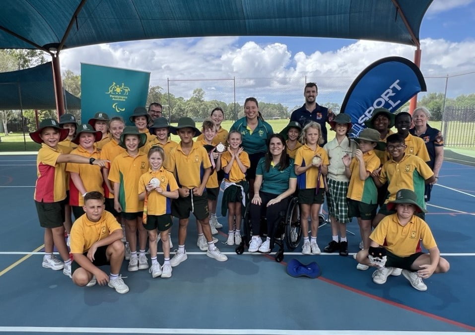 Para-athletes Ella Sabljak and Monique Murphy are surrounded by school children visit to St Pauls Lutheran College in Caboolture.